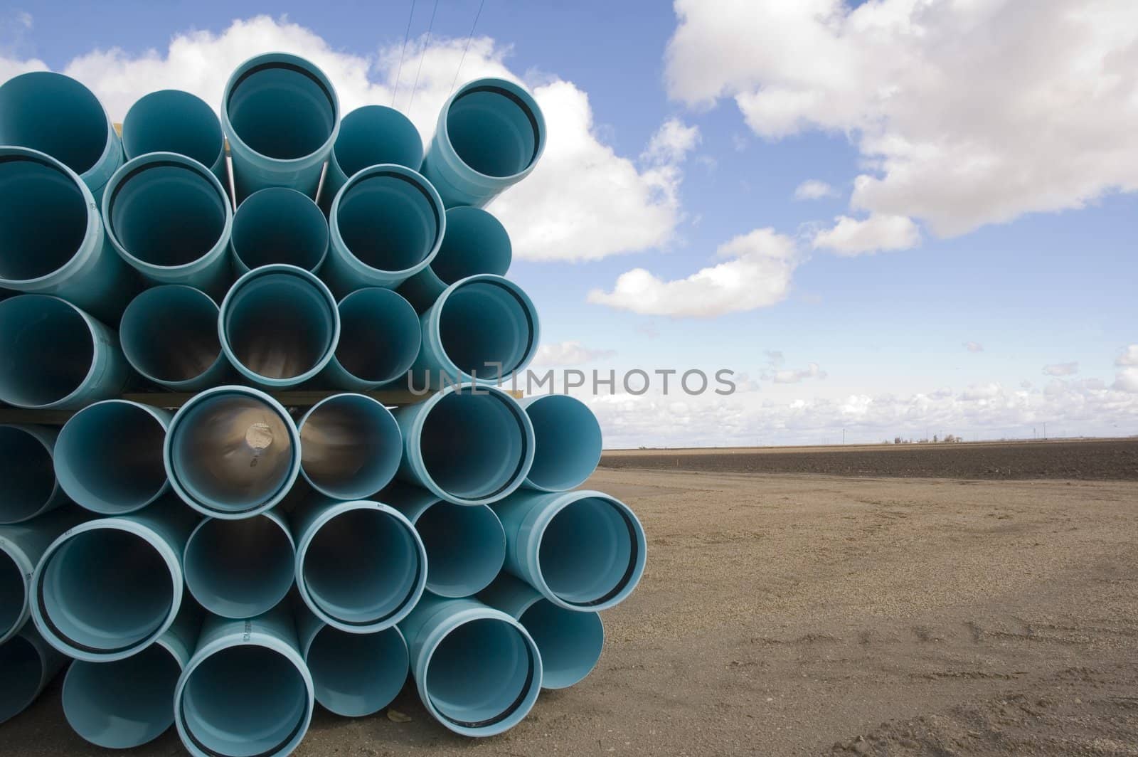 Agricultural irrigation piping stacked on farm