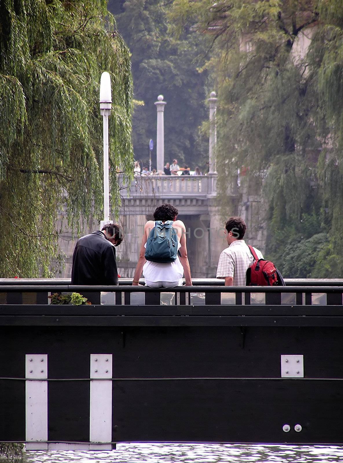 Three young persons at footbridge.