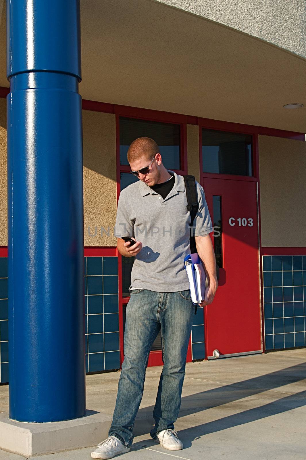 Young college students outside of a classroom at a public university