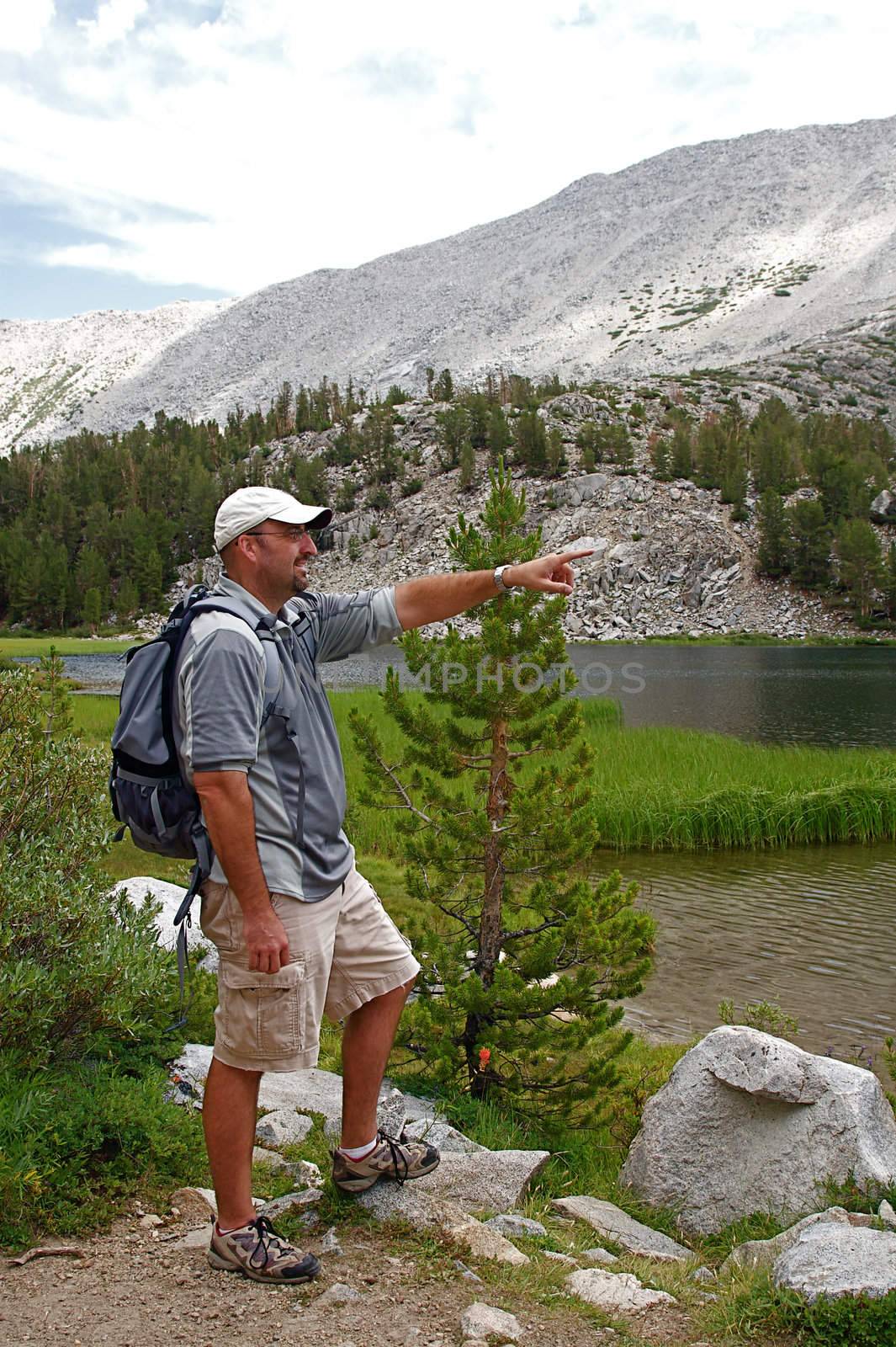 Hikers traverse the high country meadows of an alpine range