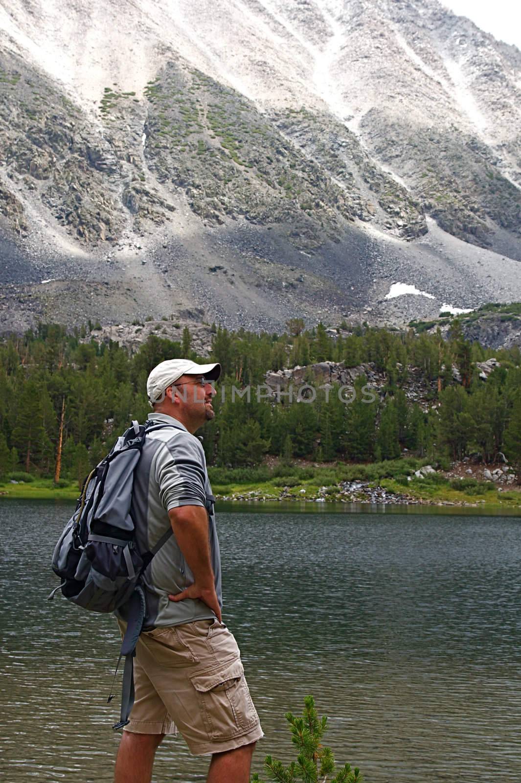 Hikers traverse the high country meadows of an alpine range