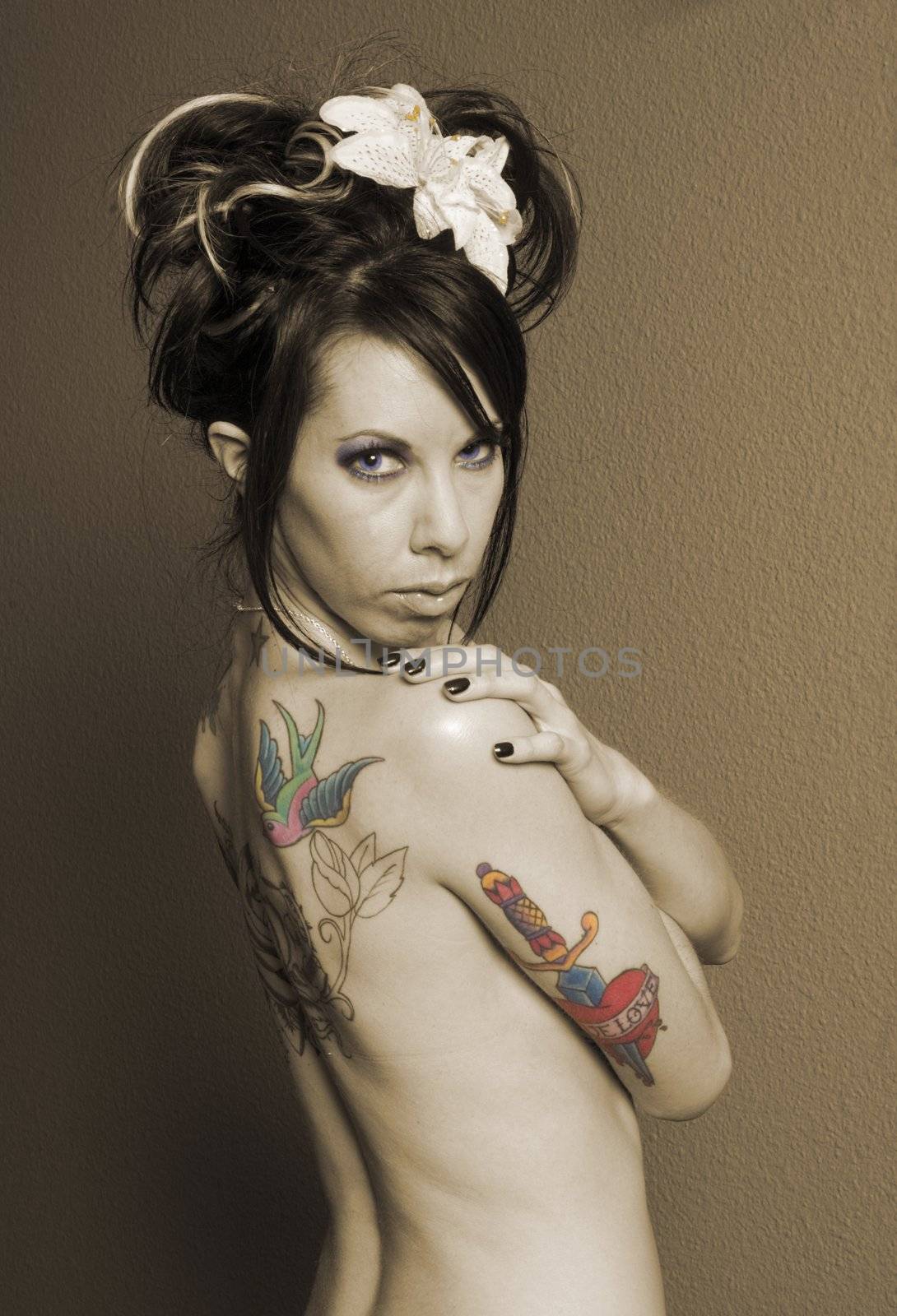 Pretty girl with tattoo's on back in sepia, layered then erased so that eyes, stamen and tattoo's are in color