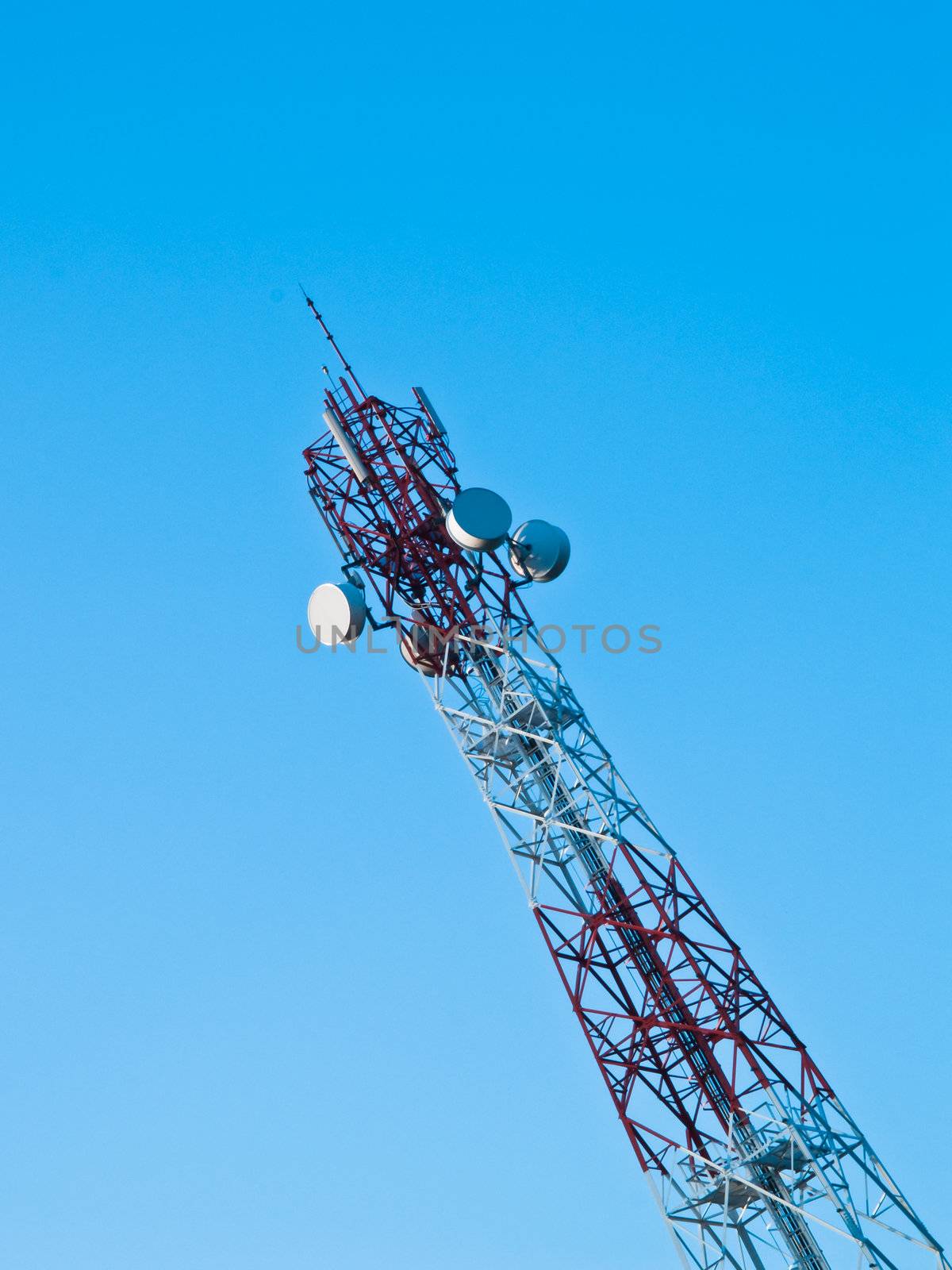 Mobile phone communication repeater antenna tower in blue sky