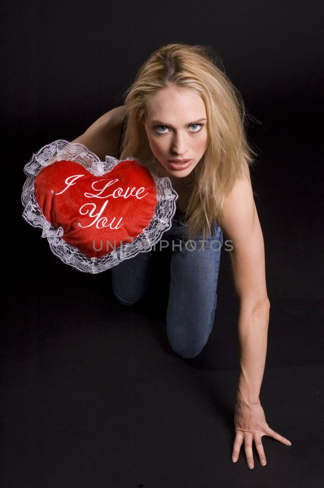 hot sexy Valentine kneeling on the floor in a black room