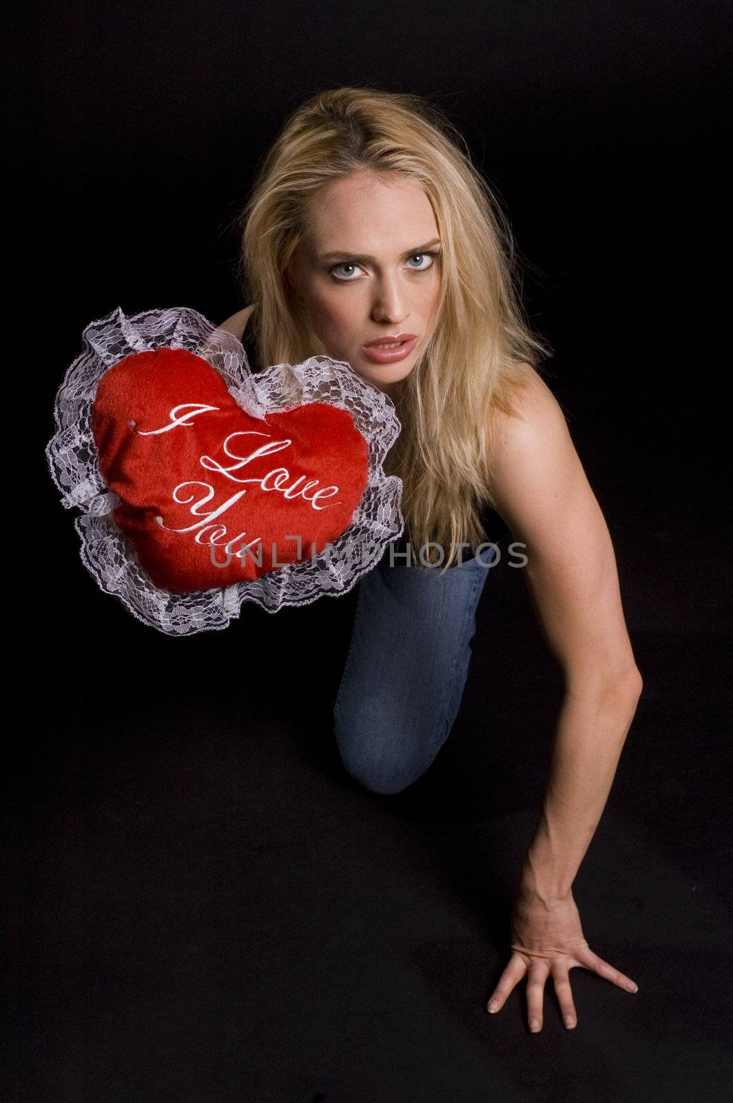 hot sexy Valentine kneeling on the floor in a black room