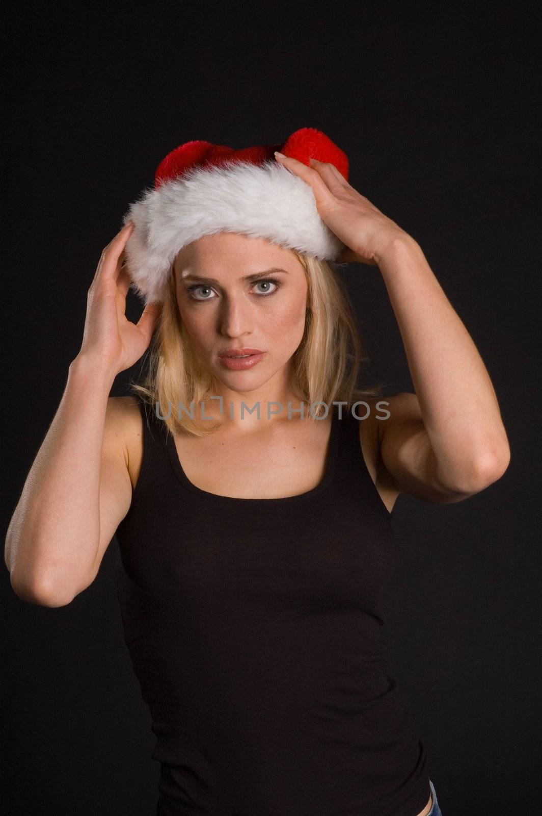 Santa's helper putting on her hat