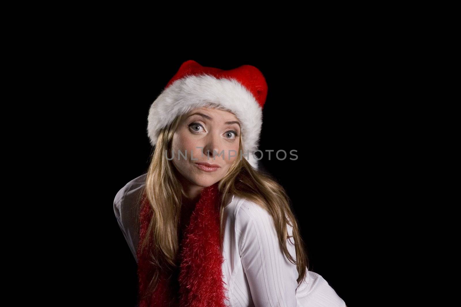 Attractive woman wearing a santa hat  and boa over a black background