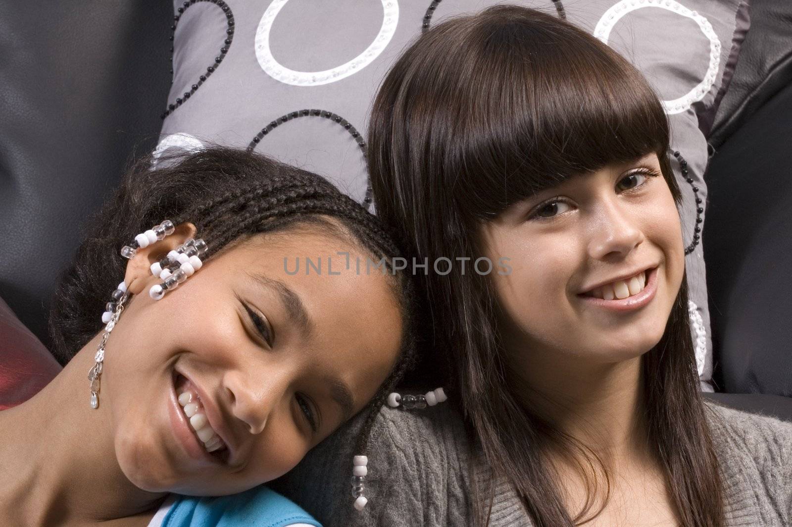 cute african american girl resting head on the shoulder of caucasian girl freind