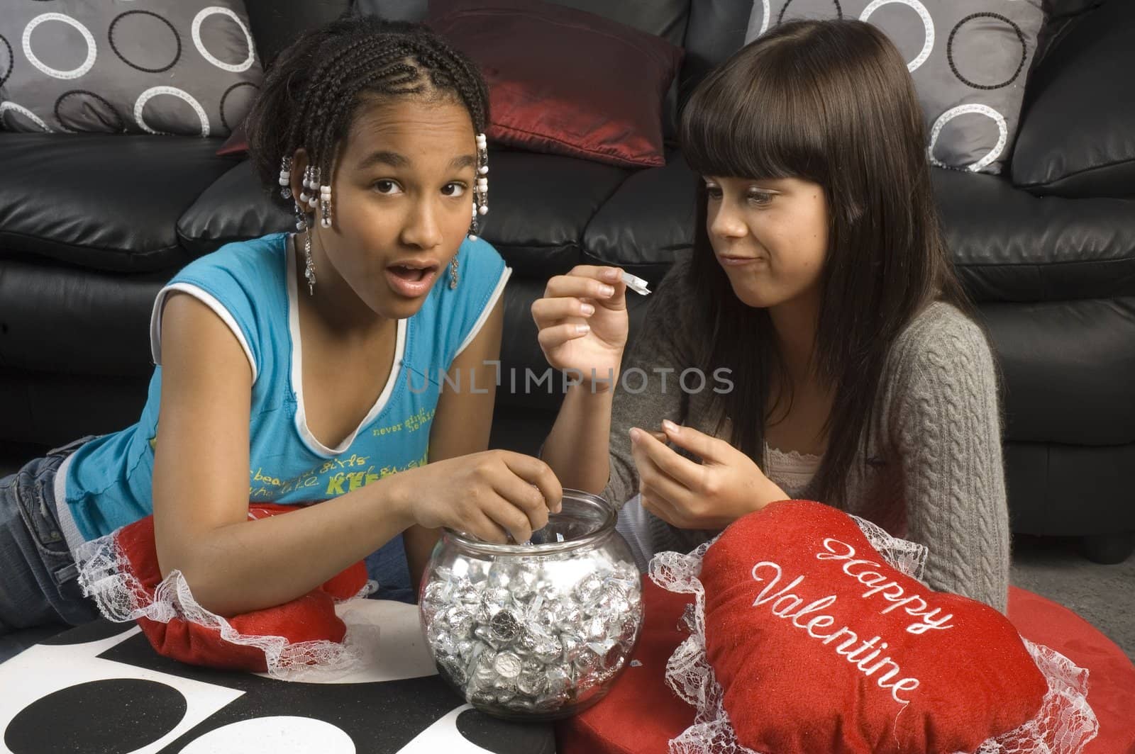 two young girls eating chocolate