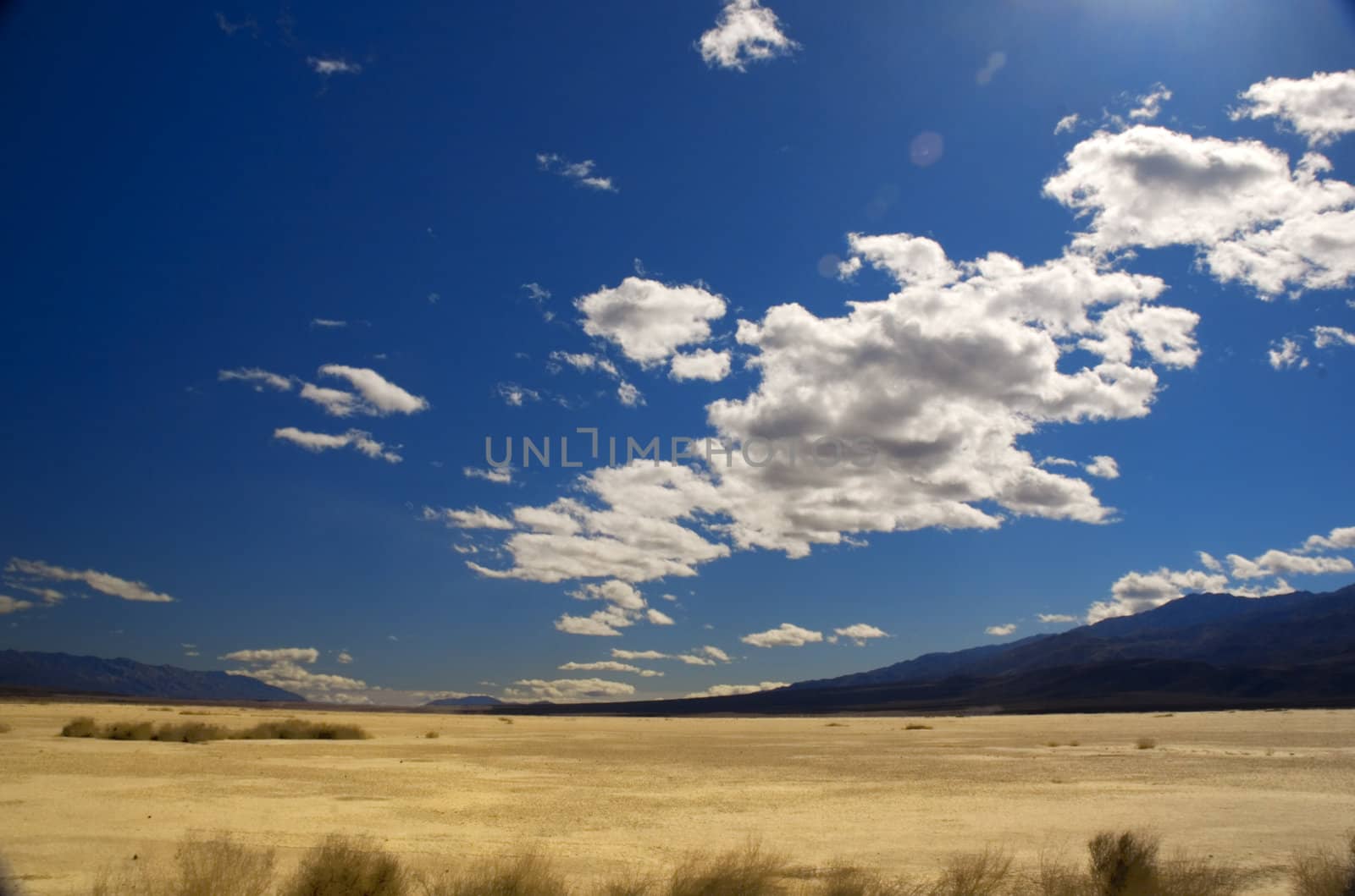 clouds over death valley with a little flare from the sun for effect