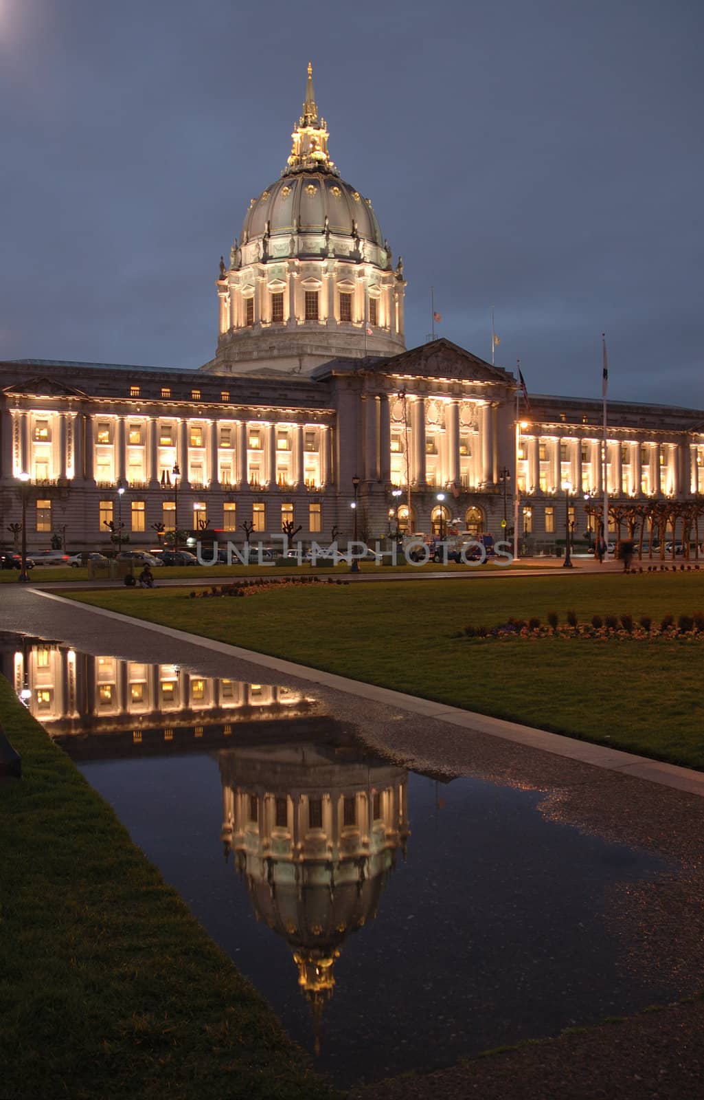 San Francisco Civic Center illuminated at night.with a reflection after a rain