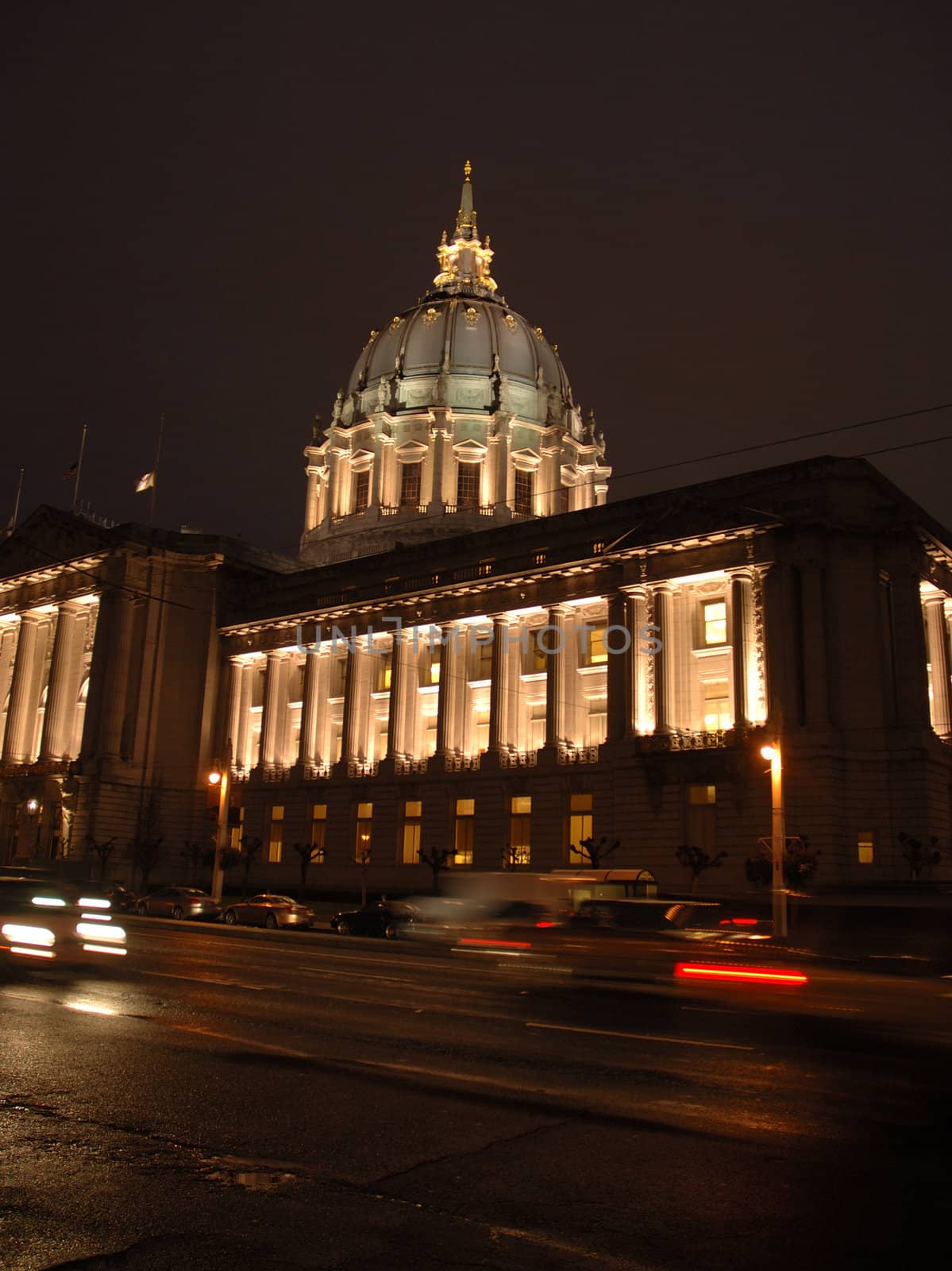 San Francisco Civic Center illuminated at night.with a reflection after a rain