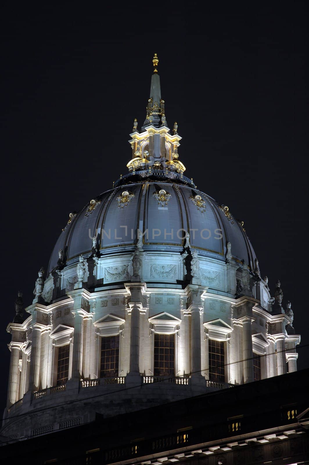 San Francisco Civic Center illuminated at night.with a reflection after a rain