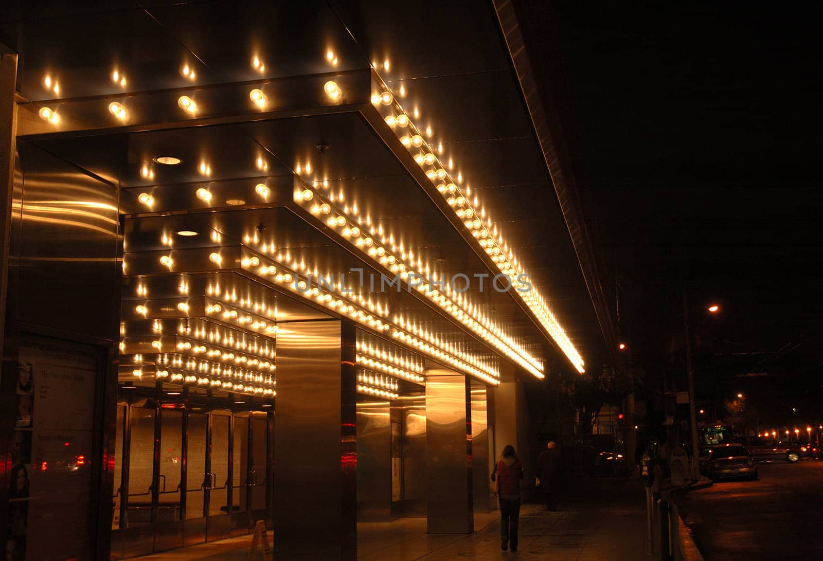 San Francisco opera house entrance illuminated at night.with a reflection after a rain