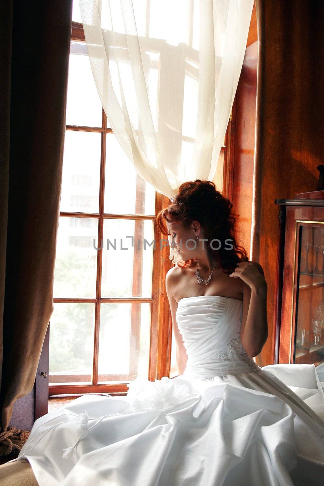 Young bride sat by window by speedfighter
