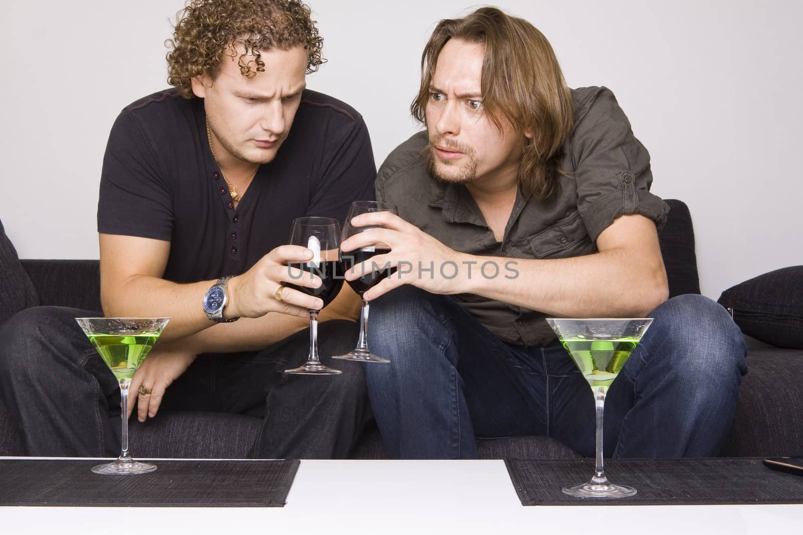 two friends drinking at home (grimacing)