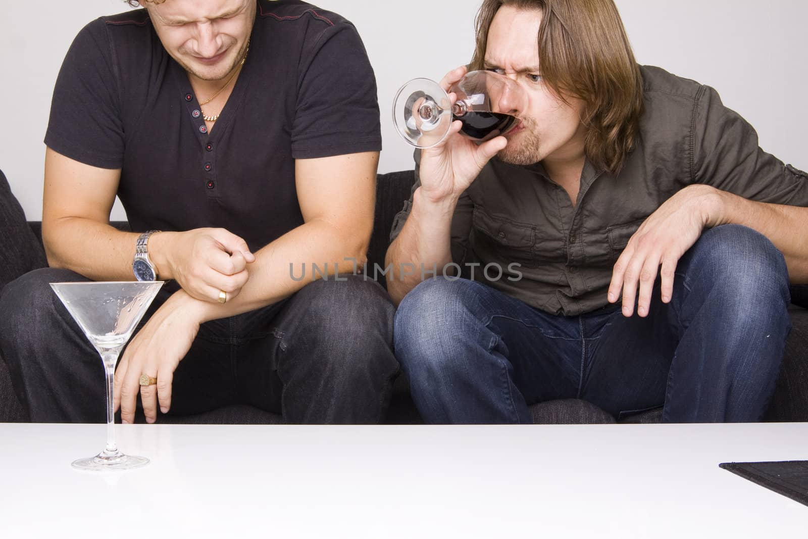 two friends drinking at home (grimacing)