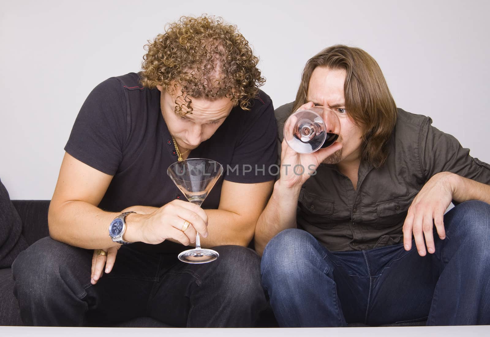 two friends drinking at home (grimacing)