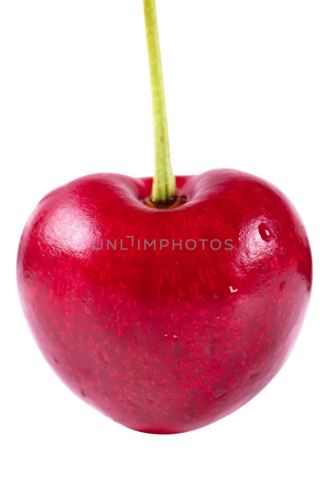 Close up view of heart shaped cherry isolated over white background
