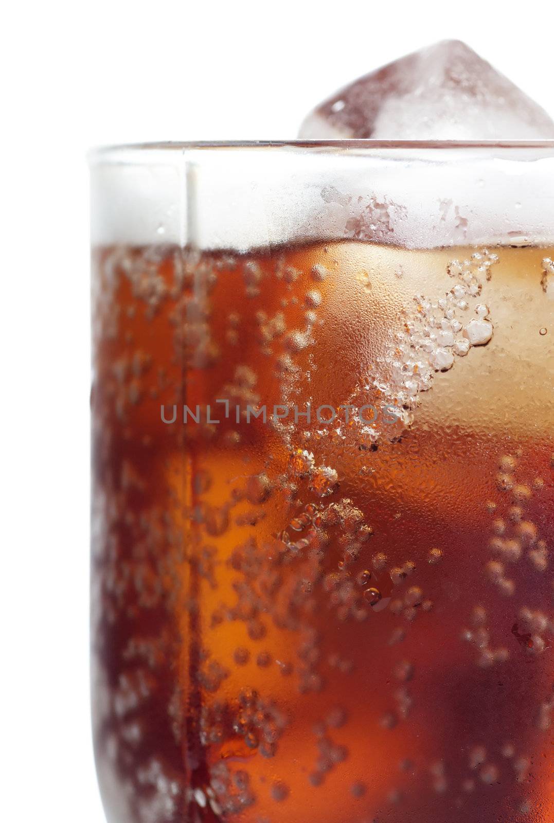 Cold cola in a glass with ice cubes over white background