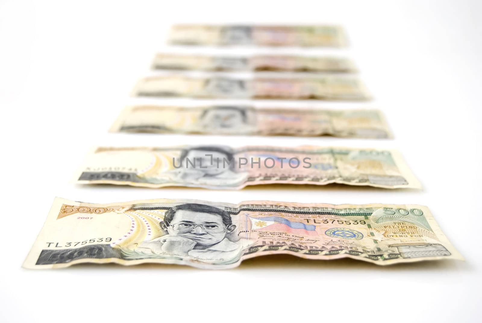 Closeup of 500-peso bills on white background