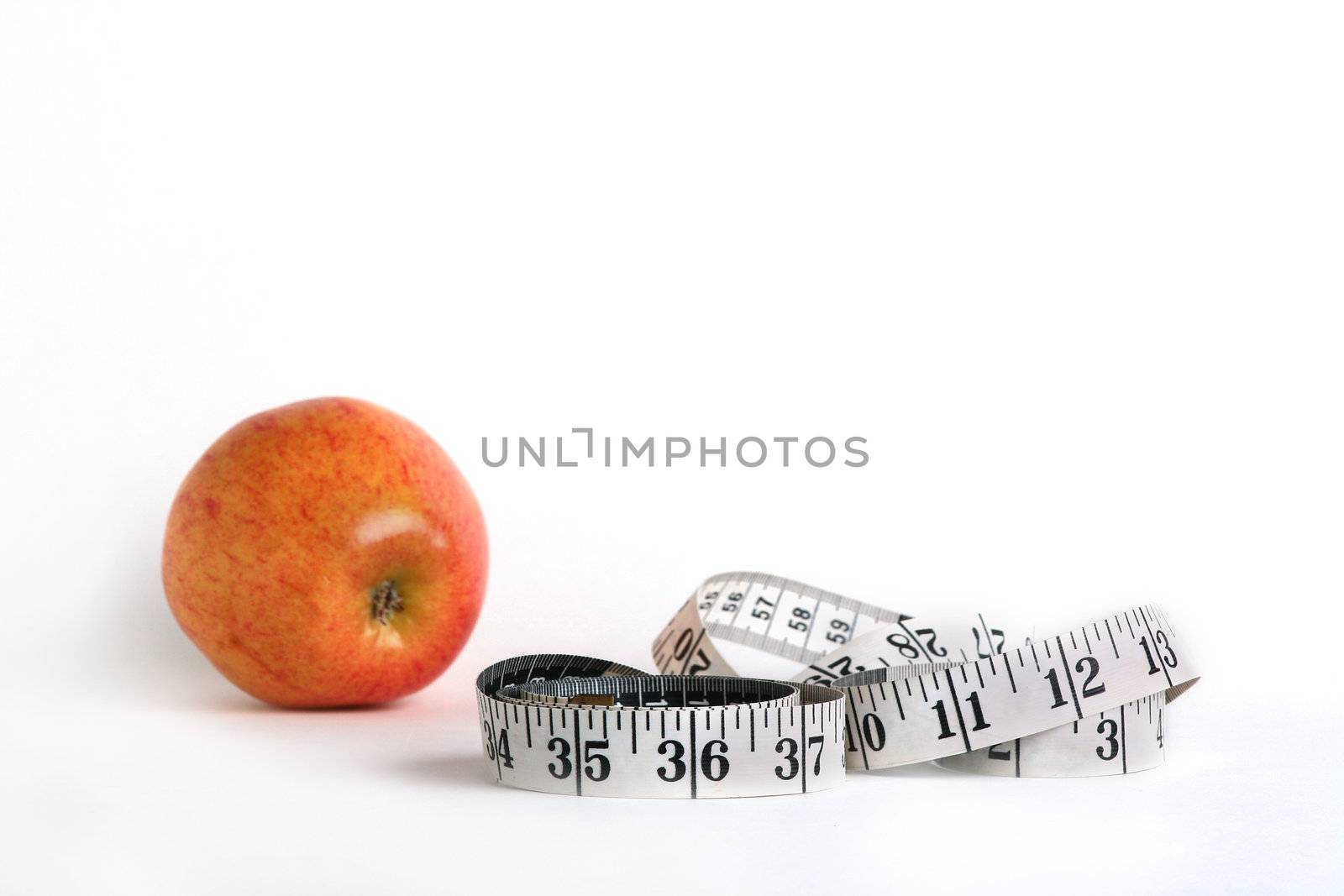 Tape measure and an apple characterise diet possibility.