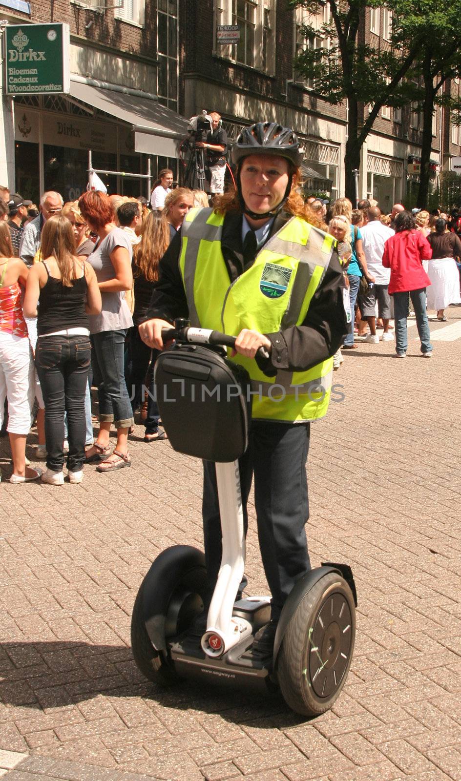 Police woman on electric scooter Segway