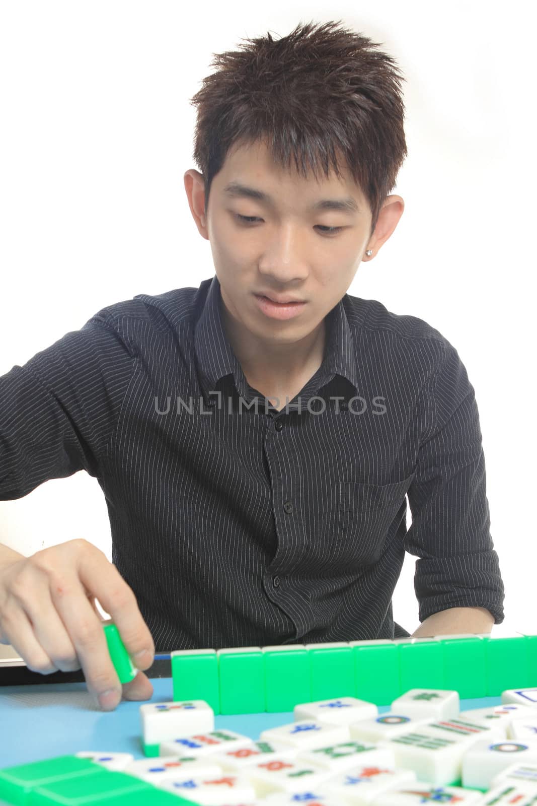 Chinese man play Mahjong, traditional China gamble.  by cozyta