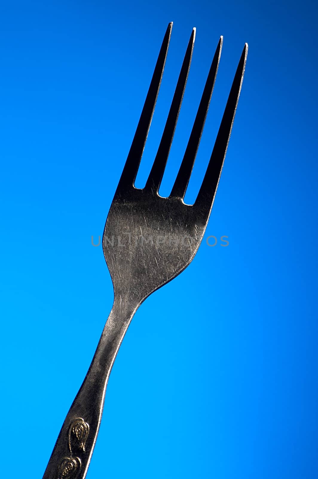 One fork on a dark blue background