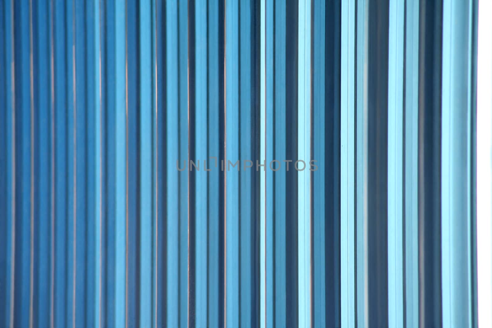 A shot of blue decorative glass tiles partitioning the windows of an office building's facade makes a great gradient background abstract. Horizontal version.
