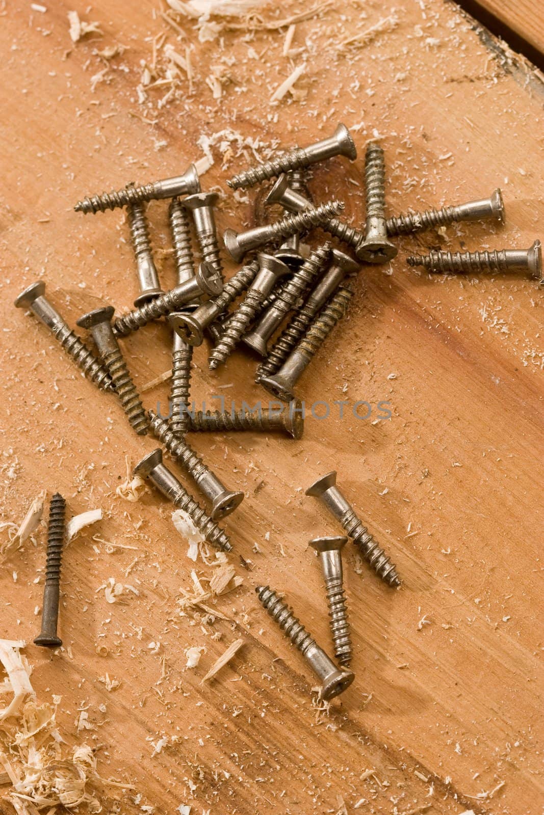 tools series: some metal screw on the wooden plank