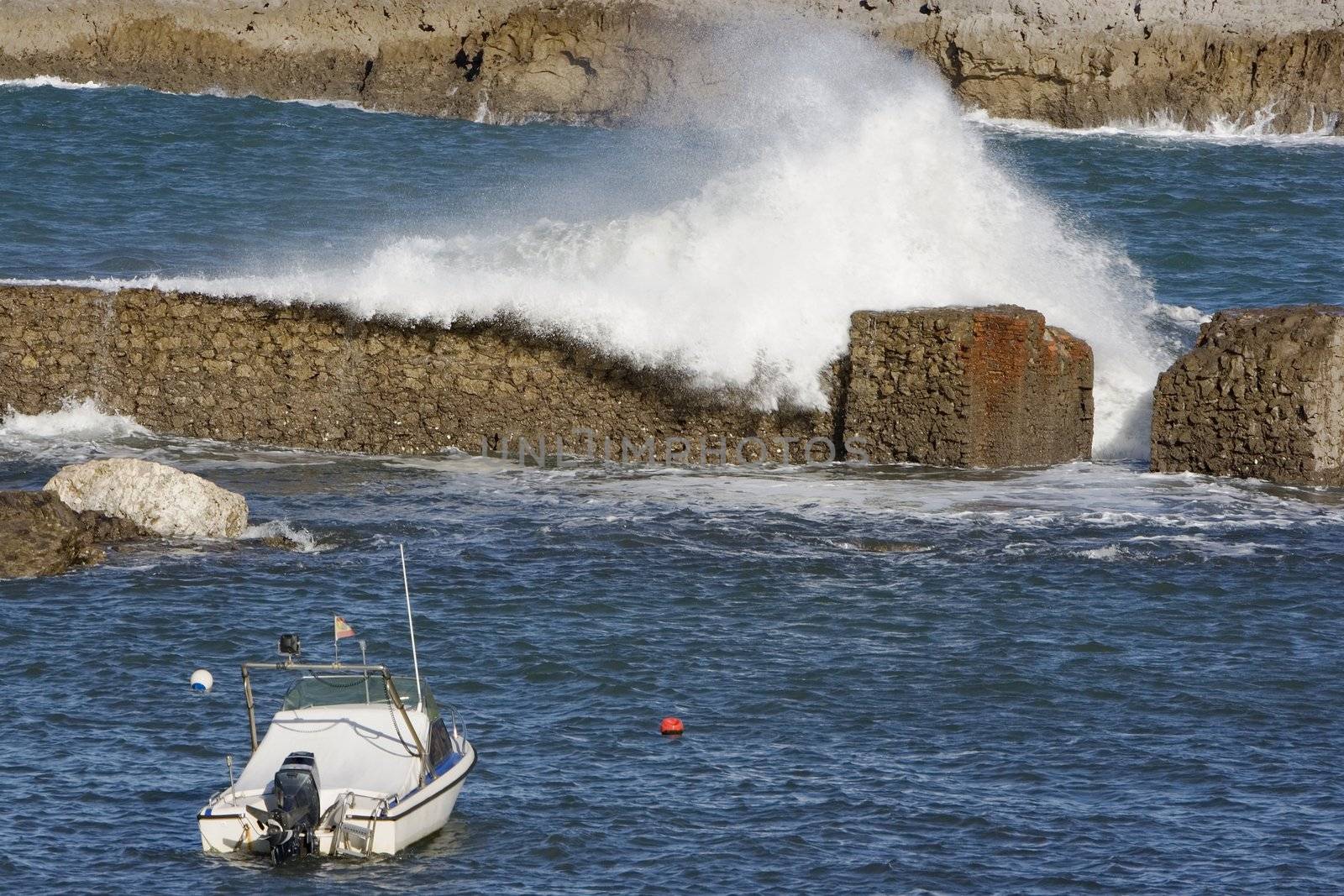 a lonely boat protected from the wild sea