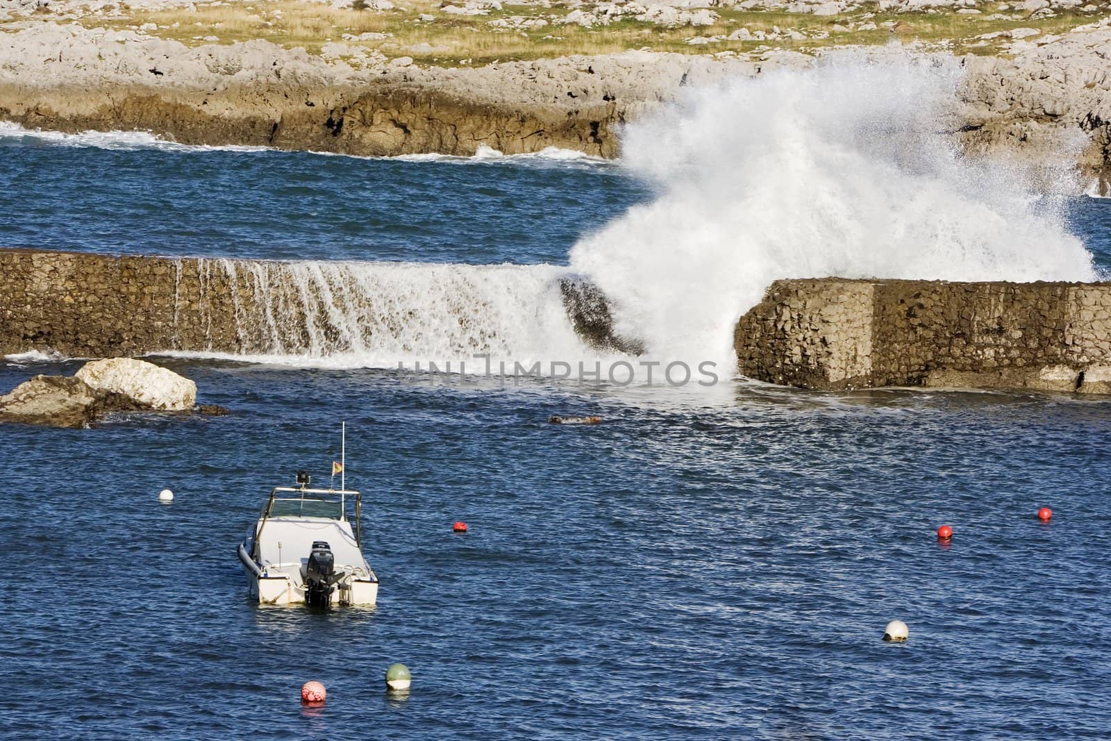 a lonely boat protected from the wild sea