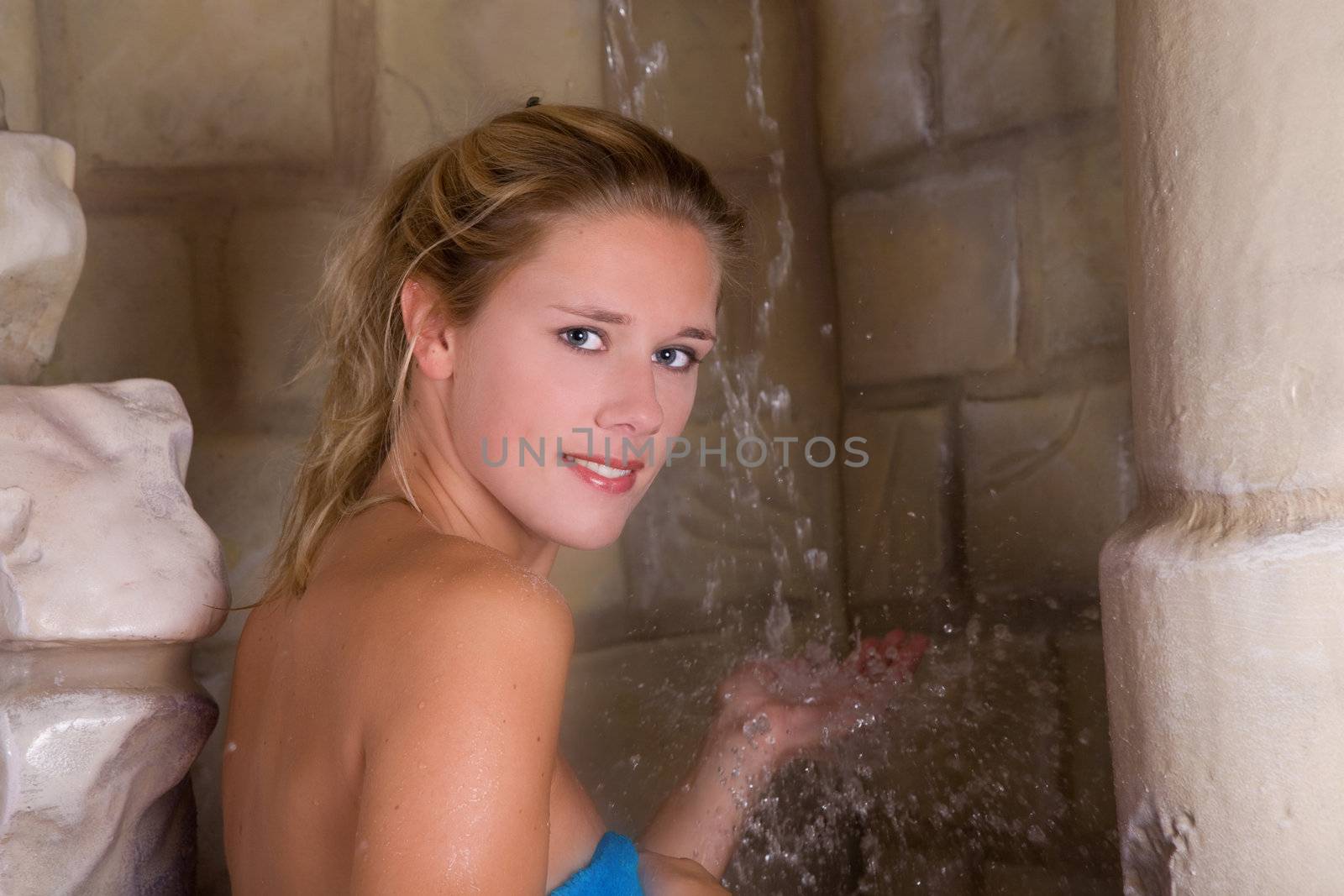 Pretty blond woman about to take a shower after having scrubbed