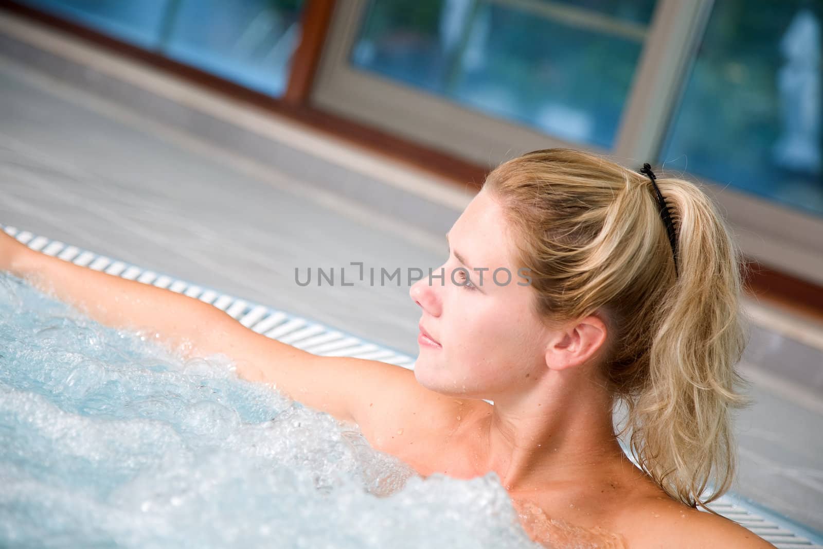 Pretty blond woman enjoying herself in a bubble bath