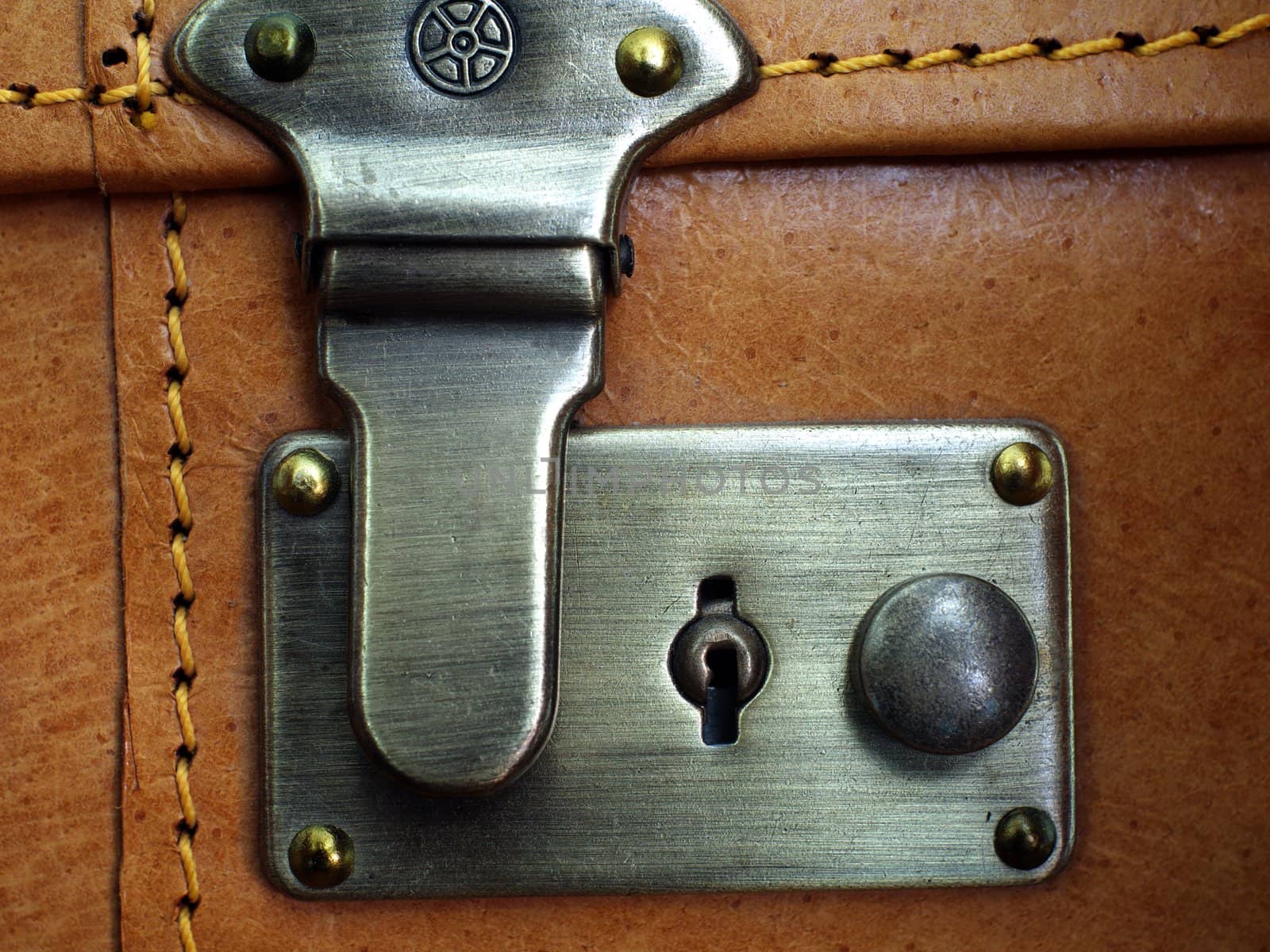 Close up of the lock on leather suitcase.