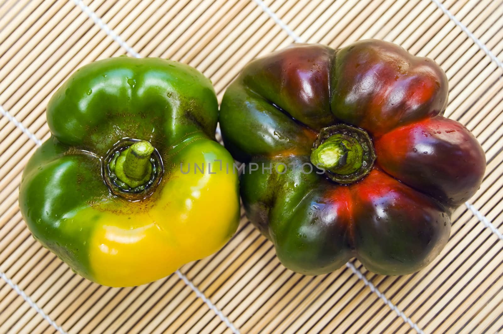 Big bell peppers on wooden mat