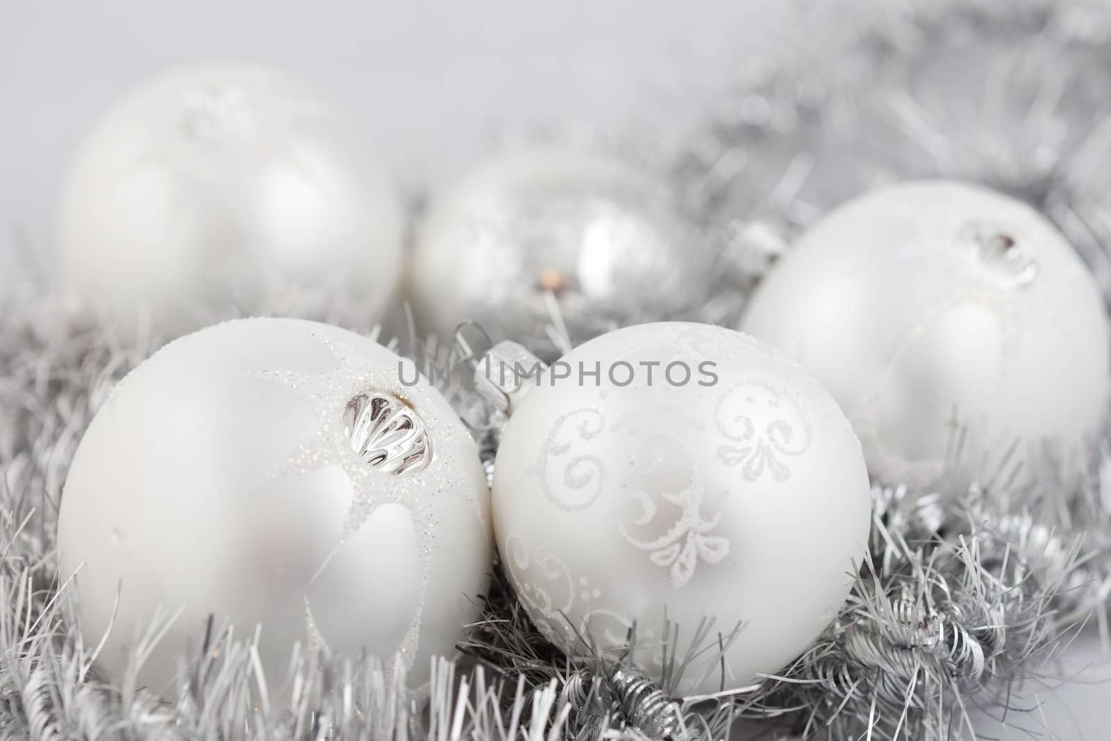 Collection of christmas baubles on silver background