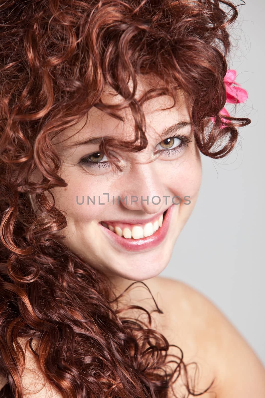 Beautiful redhaired girl in closeup portrait smiling happily
