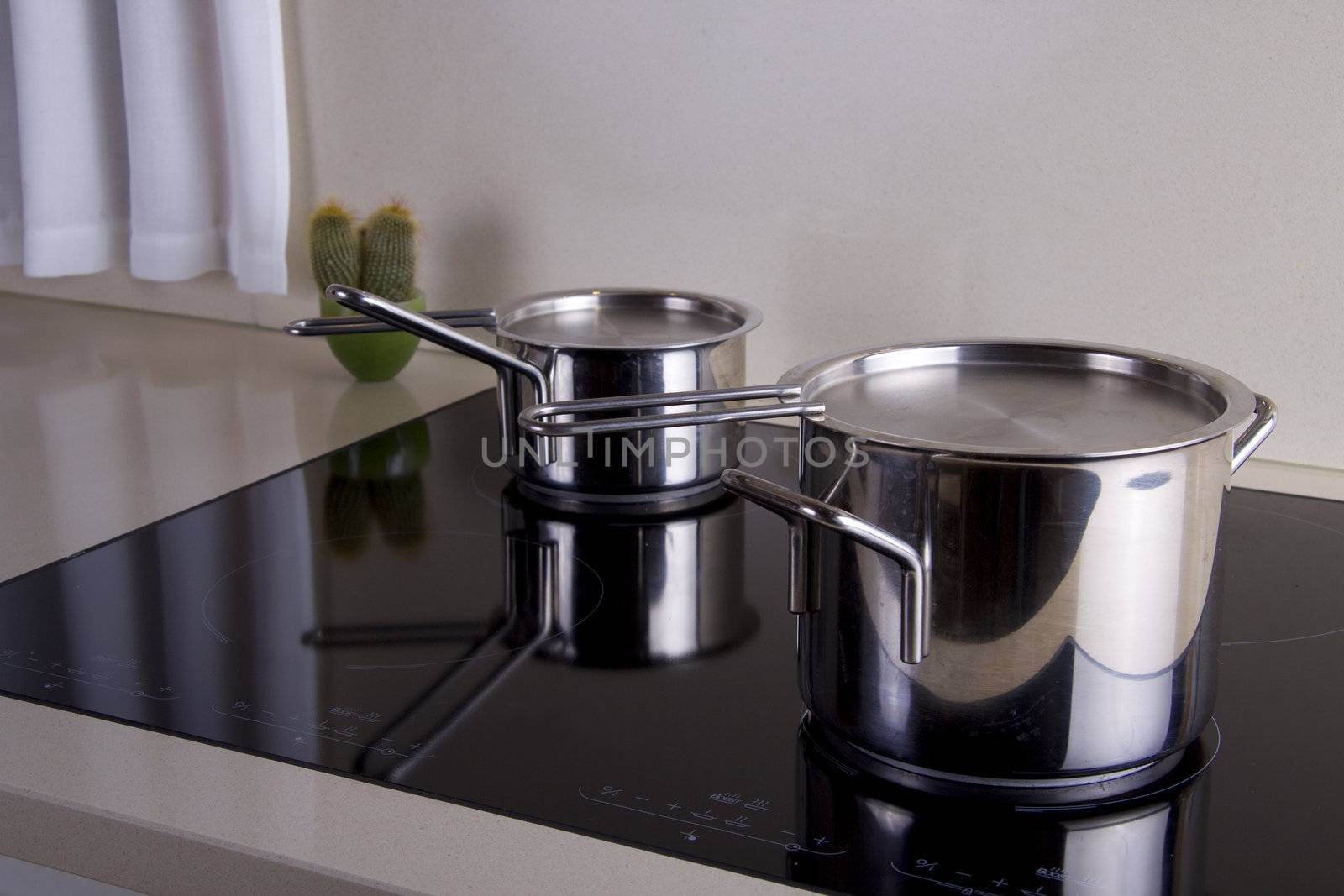 Two sauce pans in silver in a modern kitchen