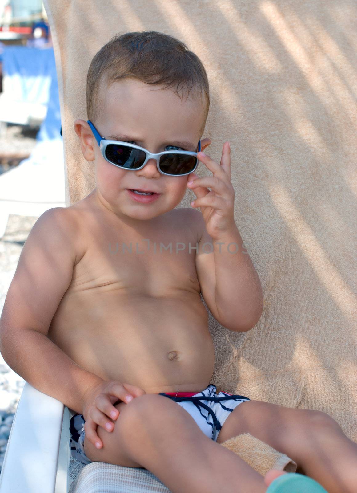 Kid with sunglasses on the beach