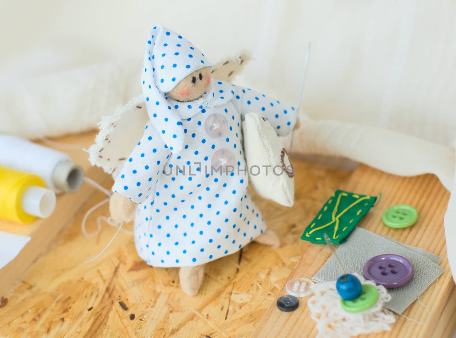 Funny handmade rag-doll with yarn and needles