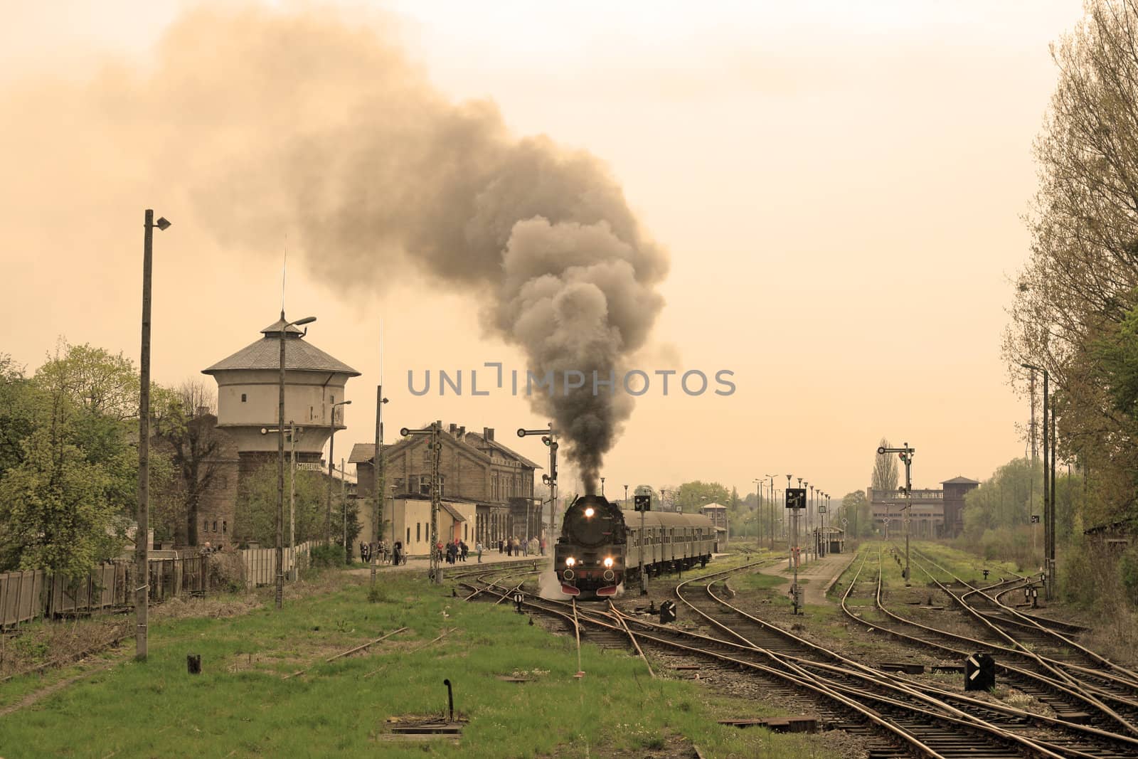 Steam retro train starting from the station
