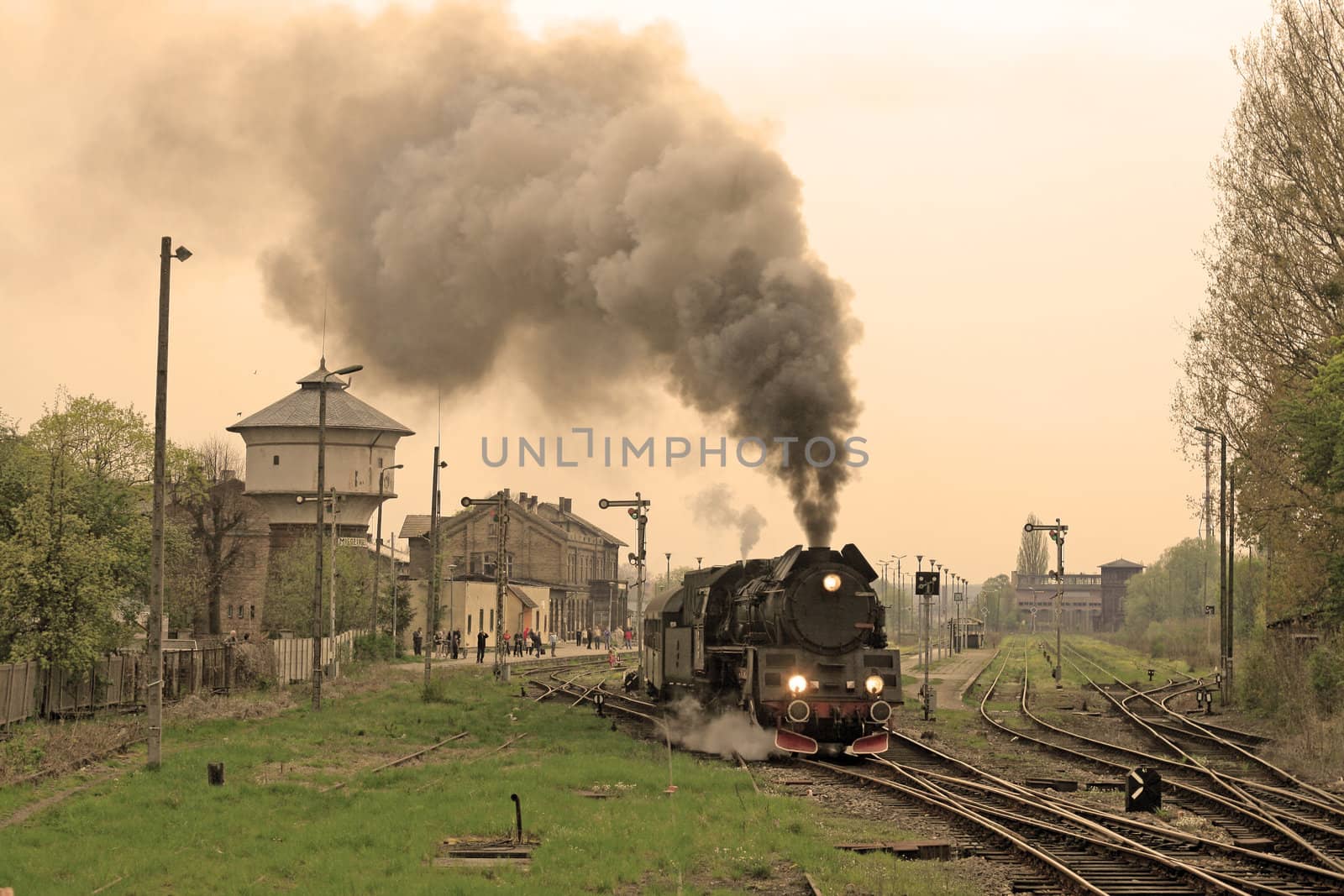 Steam retro train starting from the station
