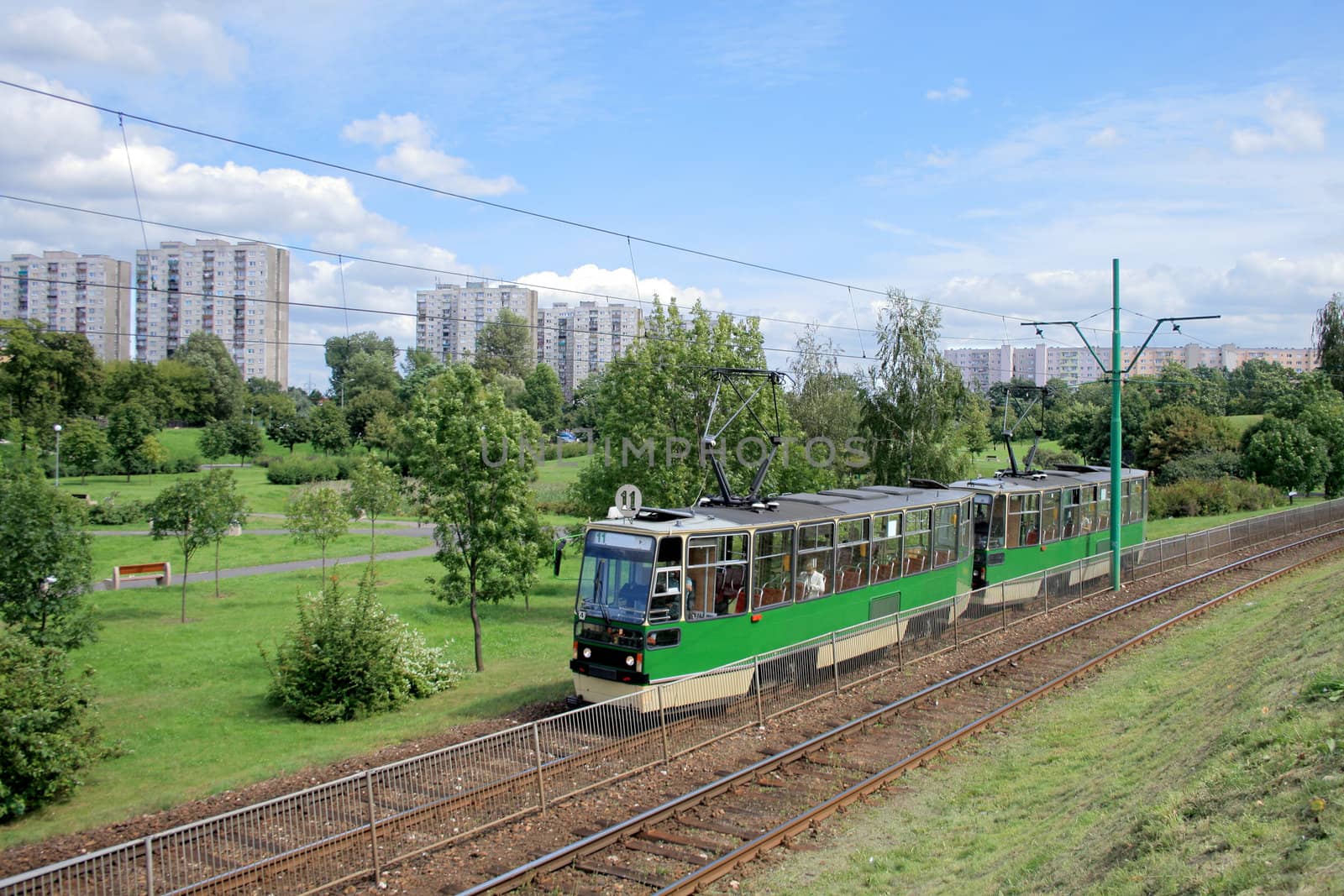 Landscape with a tram line and blocks of flats
