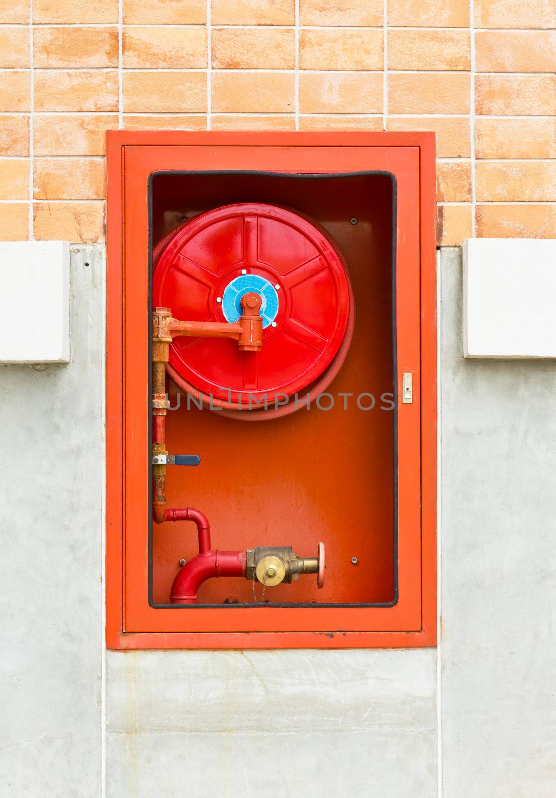 Hydrant with water hoses and fire extinguish equipment on wall