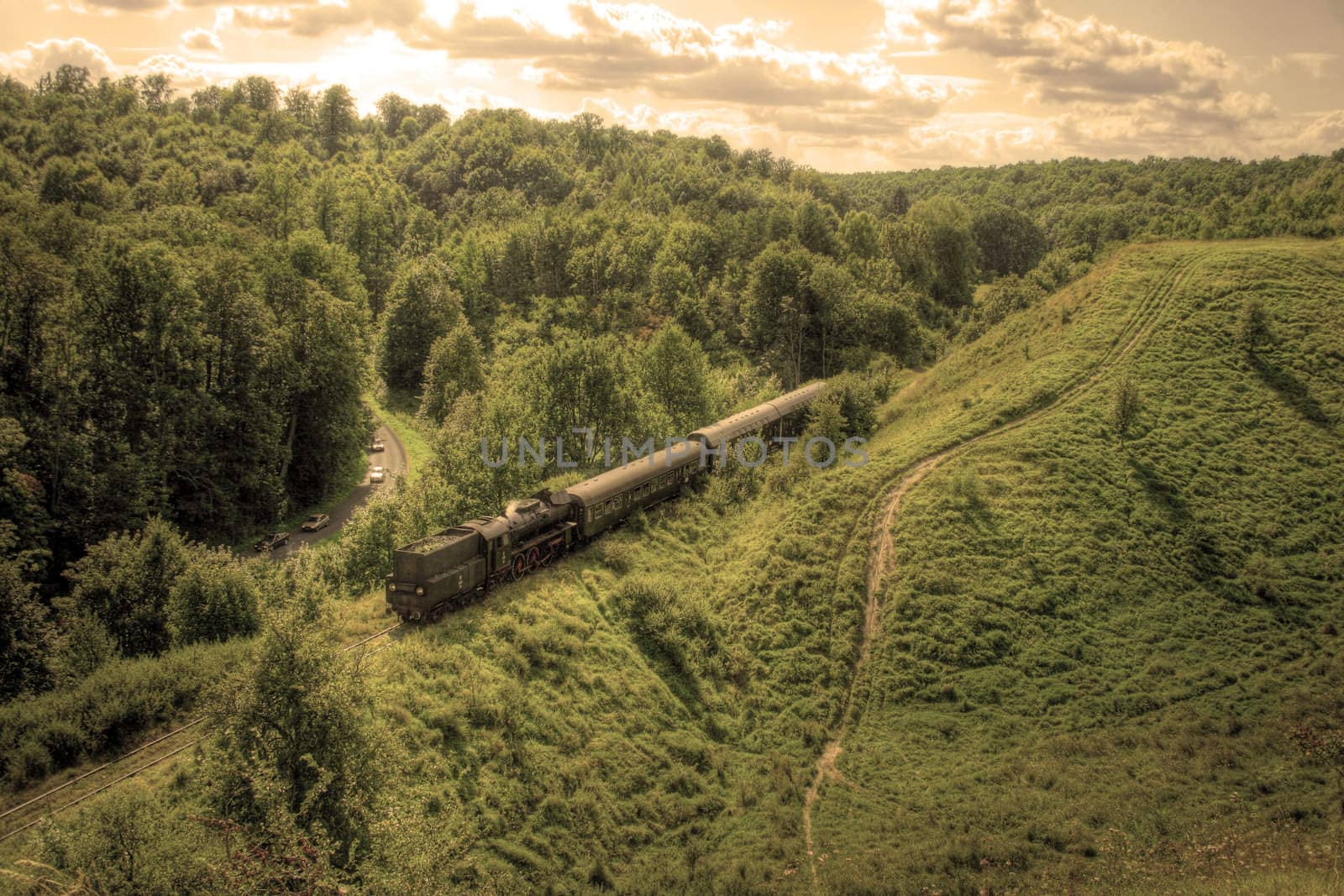 Beautiful hilly landscape with an old retro steam train
