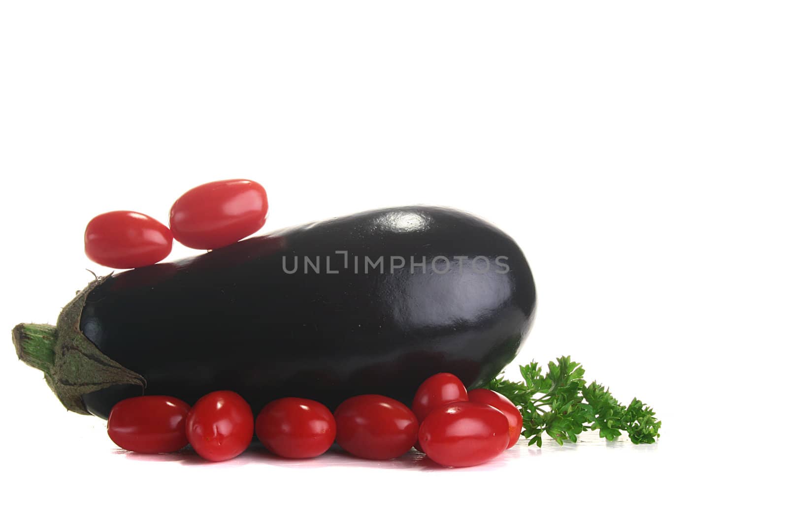 Eggplant with small tomatoes and fresh parsley.