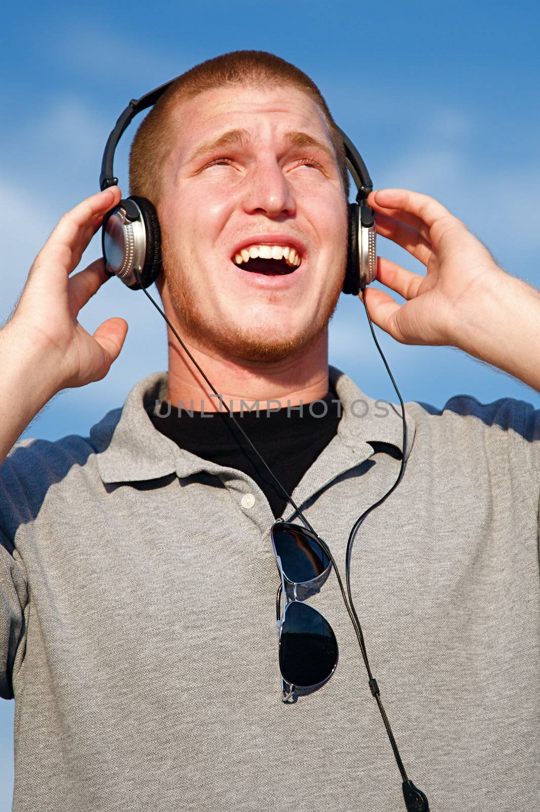 A cool young man listens to music on some headphones