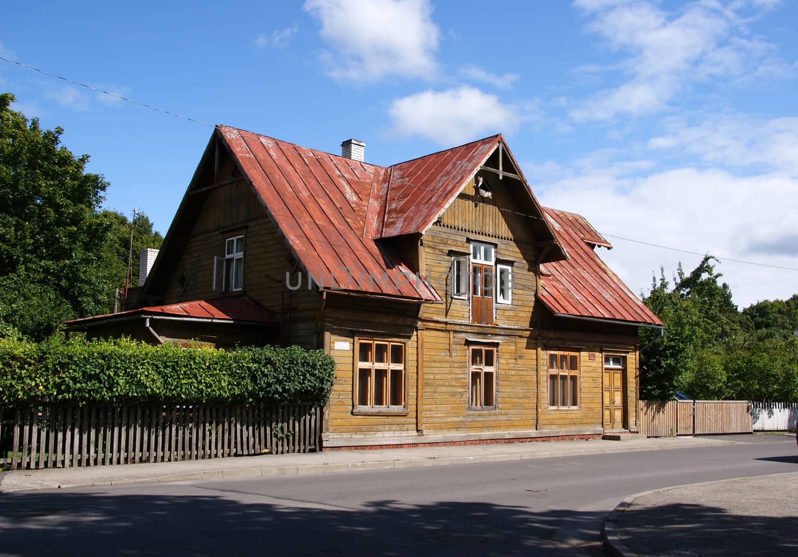 The two-storeyed wooden house is in the street of small city